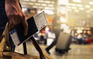 What is hypnotherapy used for? Man holding airplane ticket after flying phobia 