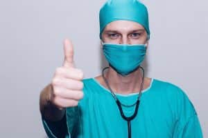 What is hypnotherapy used for? Helps with medical issues. Doctor in scrubs with a thumb up.
