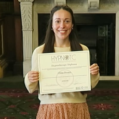 Hypnotherapy graduate, holding the hypnotherapy diploma certificate.