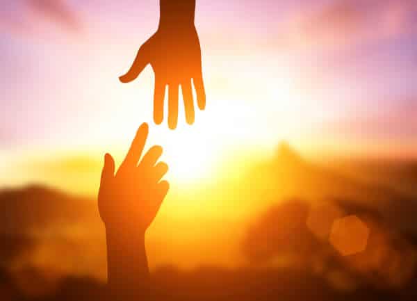 Become a hypnotherapist - two hands reaching towards each other. 