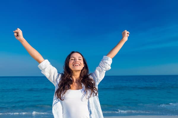 Hypnotherapy qualification and happy woman by the sea