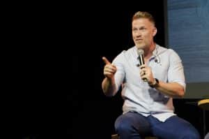 Man on stage hypnotherapy career 
