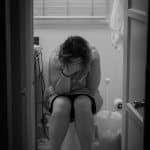 Woman with IBS - hypnotherapy training for healthcare professionals