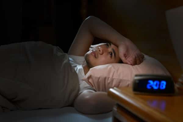 Sugar craving can keep you awake - a man in bed asleep at 2.08
