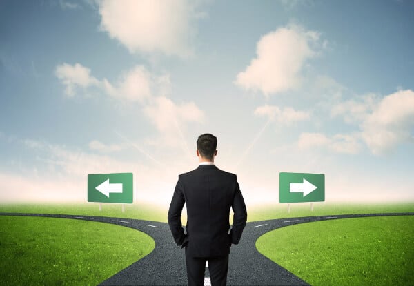 Resilience means that you can make decisions. Image of a man at a junction choosing left or right