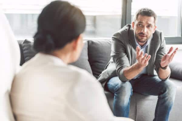 man therapist issue problem talking explaining sofa home visit hypnotherapist hypnotherapy