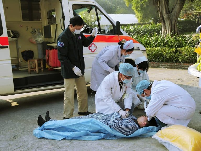 Medical emergency workers with a patient - hypnotherapy training for healthcare professionals