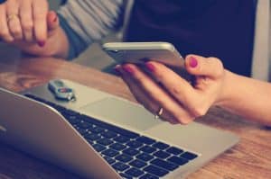 Work-life balance technology to the rescue, image of woman with phone and laptop
