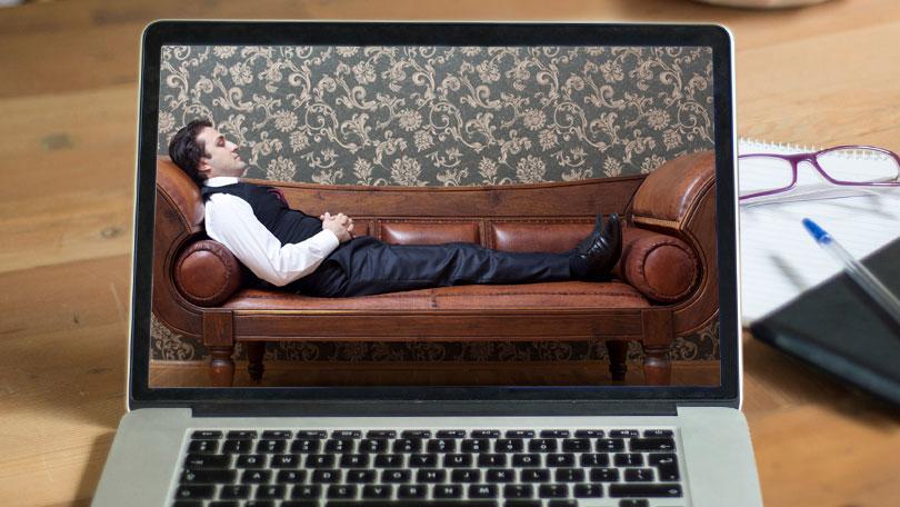Covid-19 means people can have hypnotherapy online - picture of a man reclining on a brown leather couch