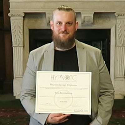 Hypnotherapy graduate, holding the hypnotherapy diploma certificate.