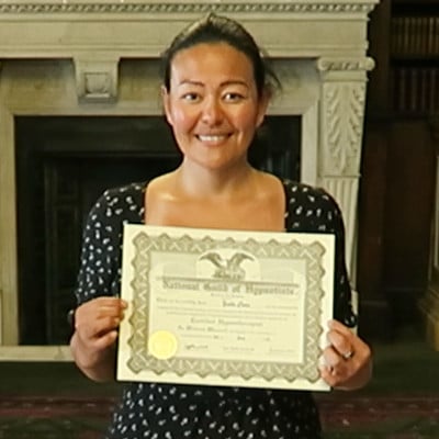 Hypnotherapy graduate, holding the hypnotherapy diploma certificate.